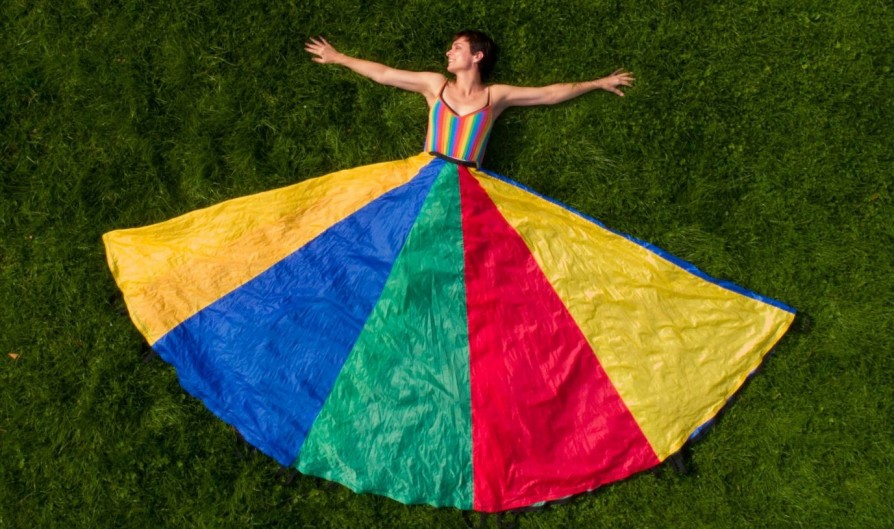 Woman on grass with a mulitcoloured dress